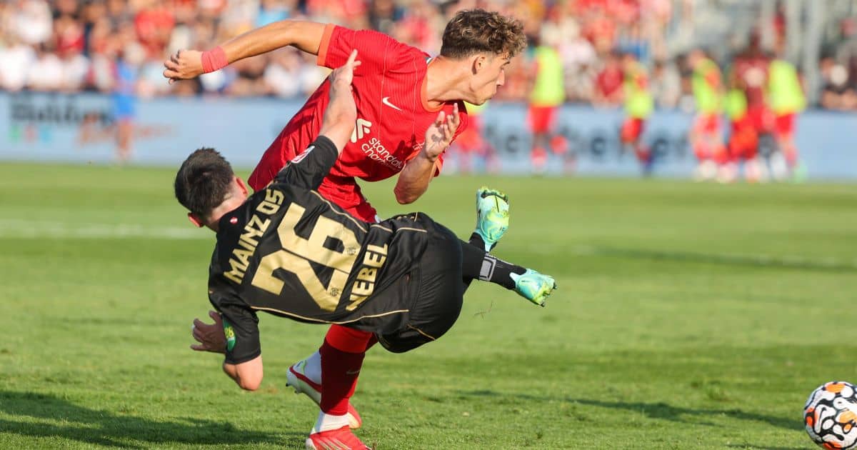 Liverpool's Kostas Tsimikas tackles for the ball against Mainz's Paul Nebel, July 2021 Kostas Tsimikas fights for the ball