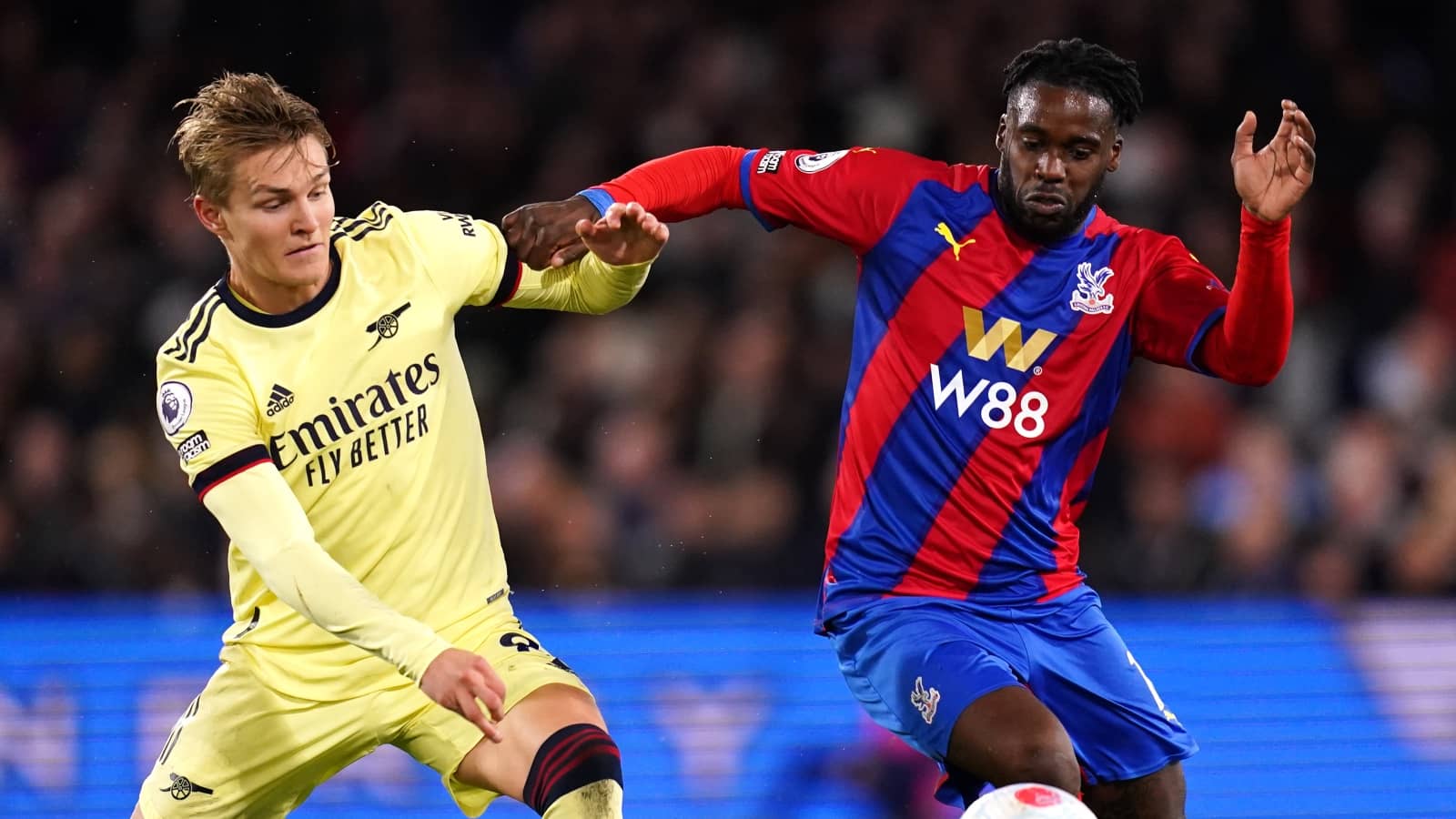Martin Odegaard battles Jeffrey Schlupp