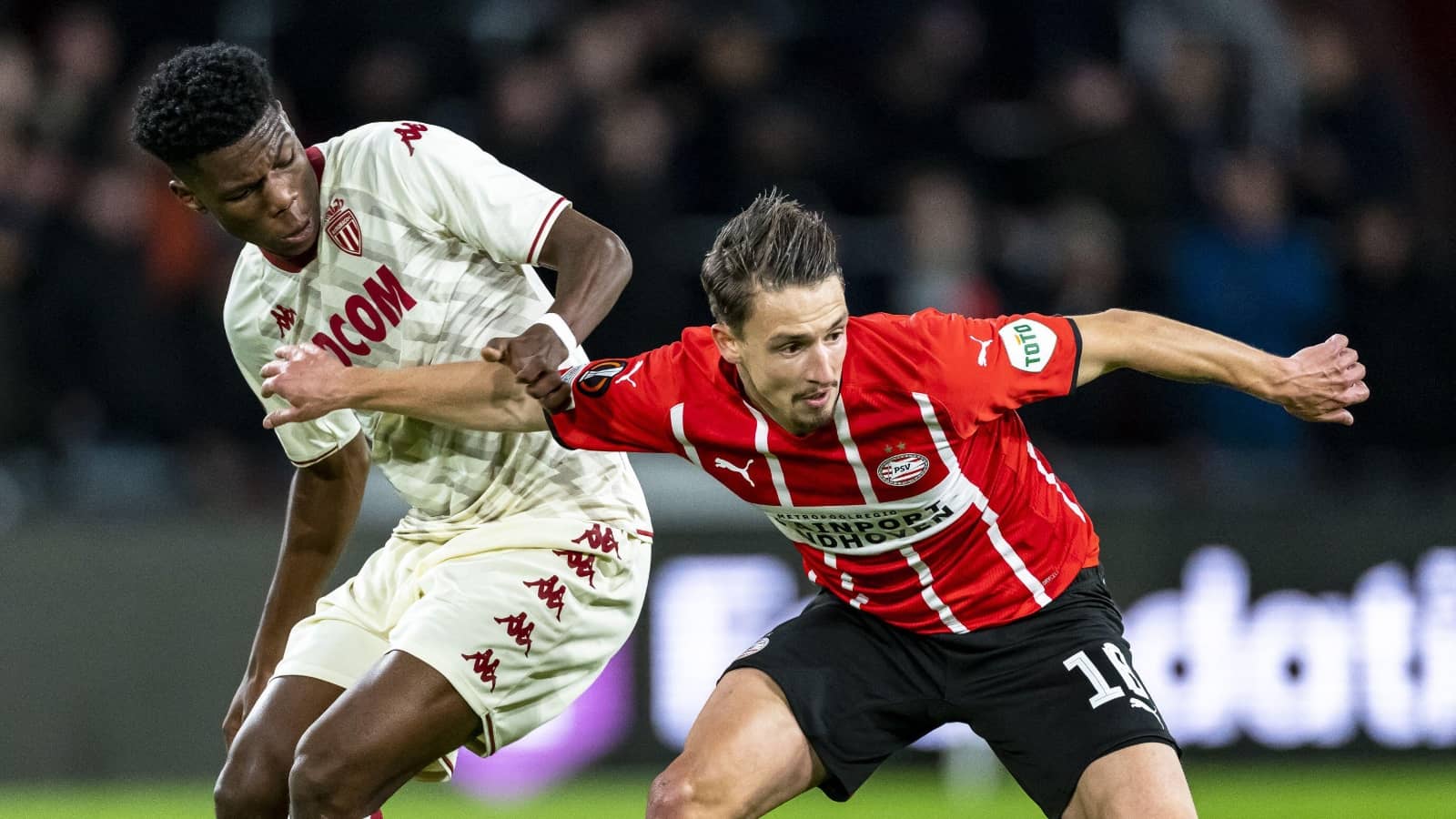 PSV player Olivier Boscagli holds off Aurelien Tchouameni of Monaco during Europa League match Olivier Boscagli and Aurelien Tchouameni