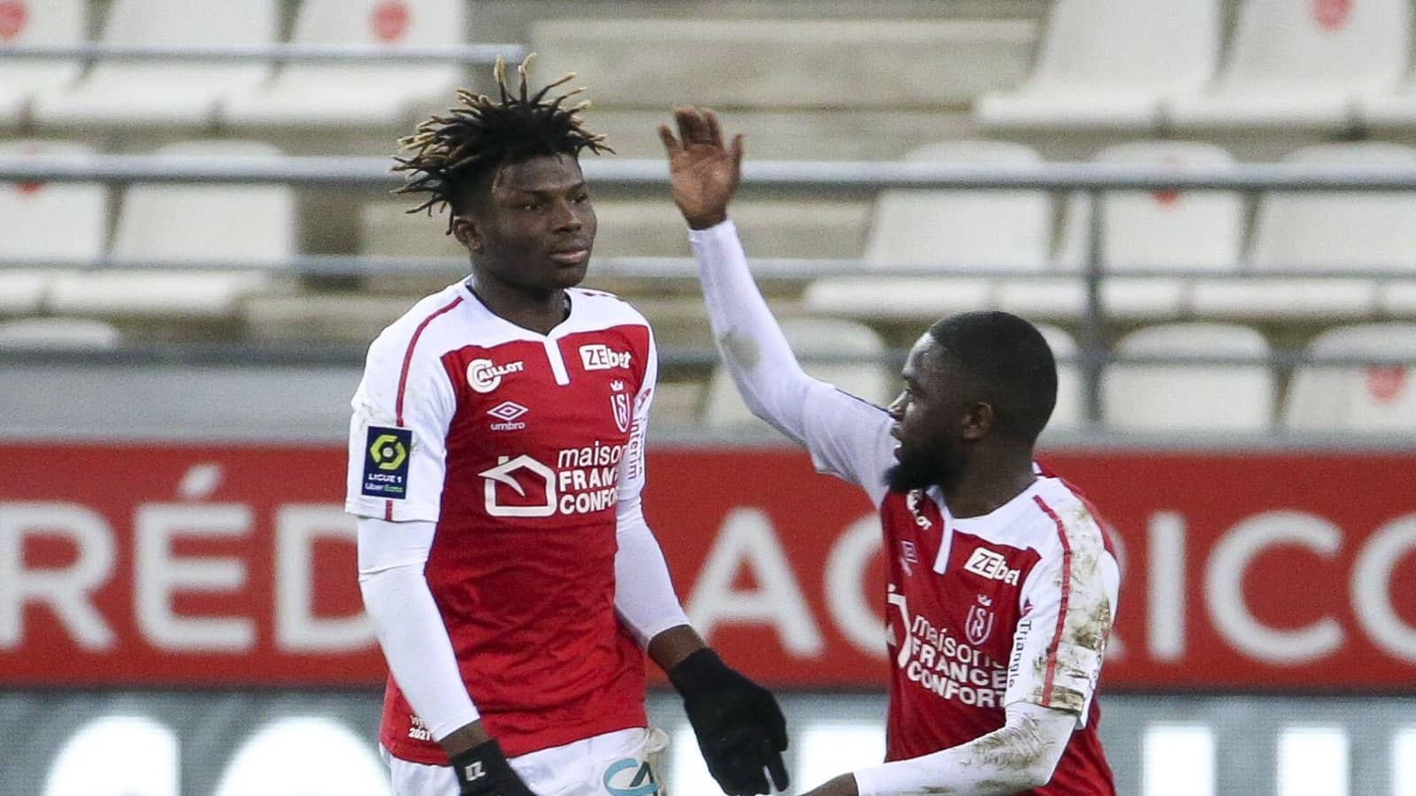 El Bilal Toure celebrates with team-mate after scoring for Stade Reims against Nantes Stade Reims forward El Bilal Toure