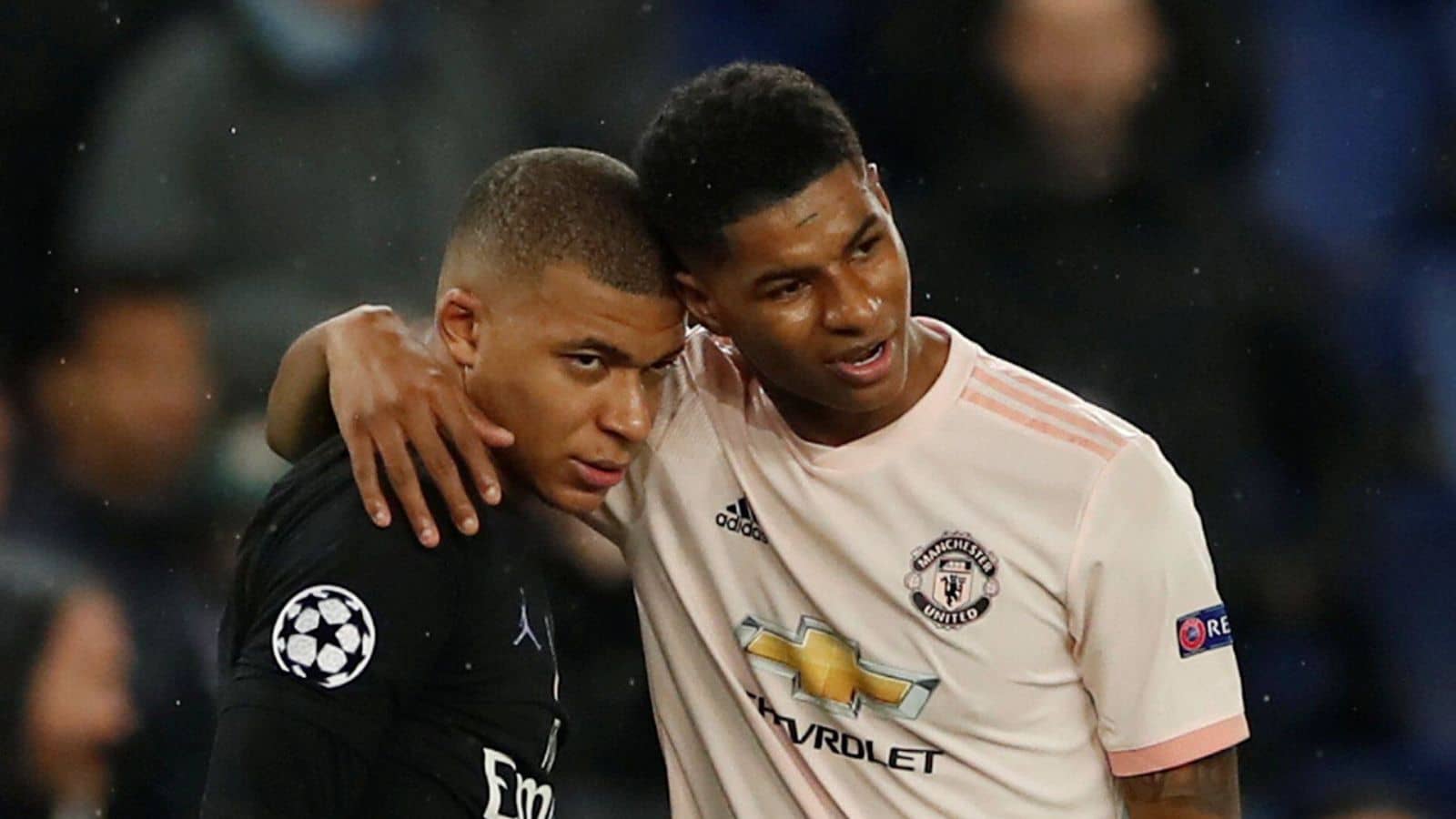 Paris St Germain's Kylian Mbappe is embraced by Manchester United's Marcus Rashford after the Champions League round of 16 clash between PSG and Manchester United