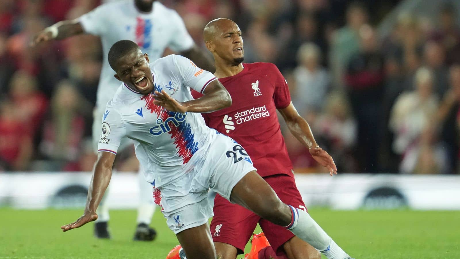Crystal Palace's Cheick Doucoure, left, is challenged by Liverpool's Fabinho during the English Premier League soccer match between Liverpool and Crystal Palace at Anfield stadium in Liverpool