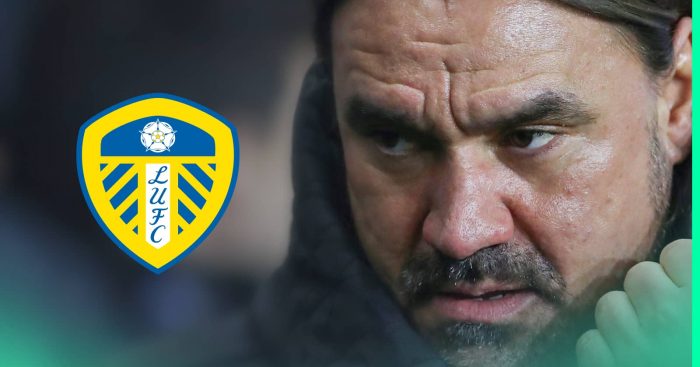 A close-up shot of Daniel Farke with a prominent Leeds United badge alongside him
