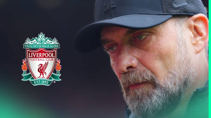 A close-up shot of Jurgen Klopp with a prominent Liverpool badge alongside him