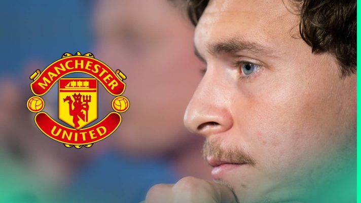 A close-up shot of Victor Lindelof facing questions in a press conference with a prominent Manchester United badge alongside him