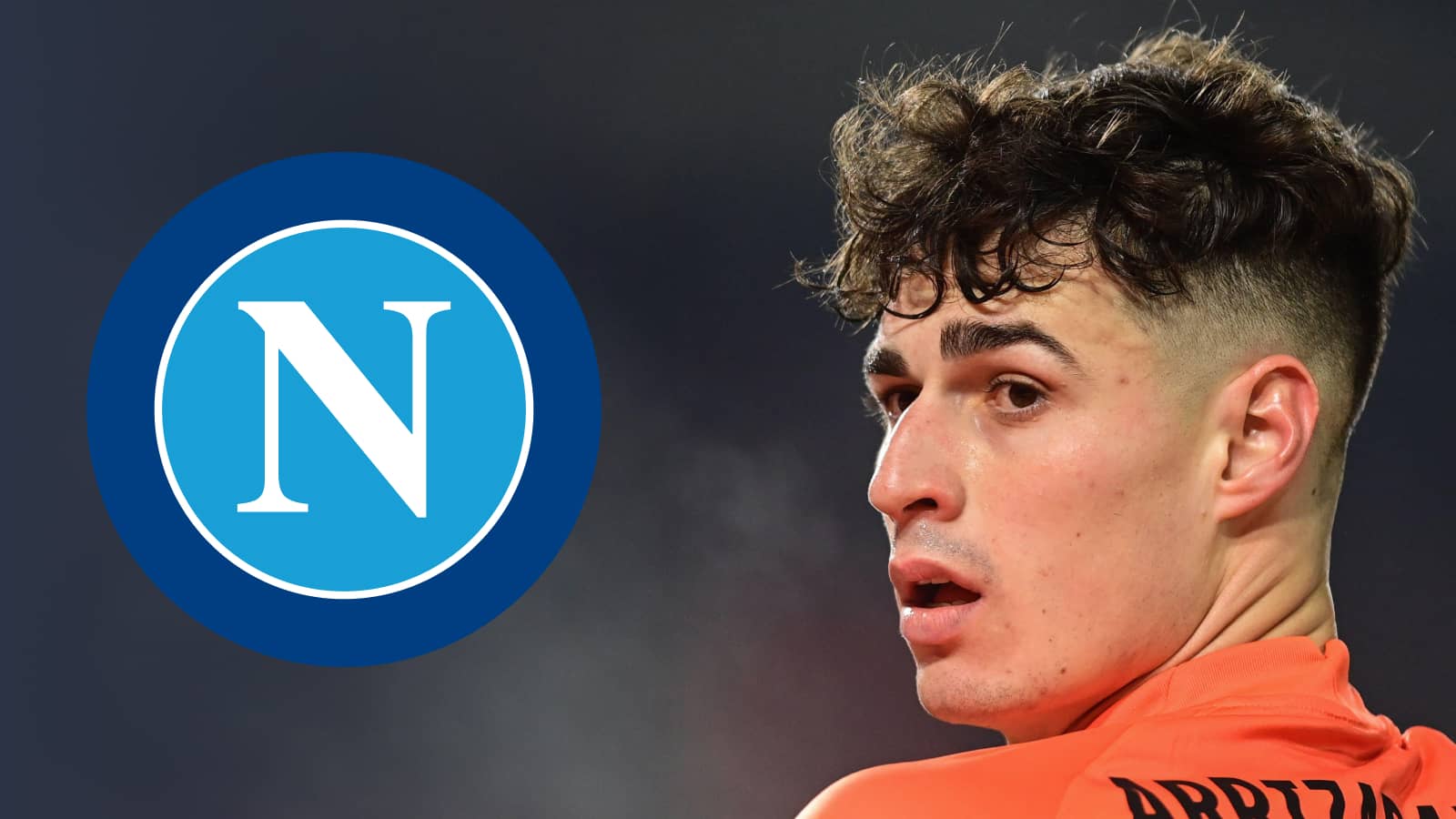 Kepa Arrizabalaga glances over his shoulder where a prominent Napoli badge sits alongside him