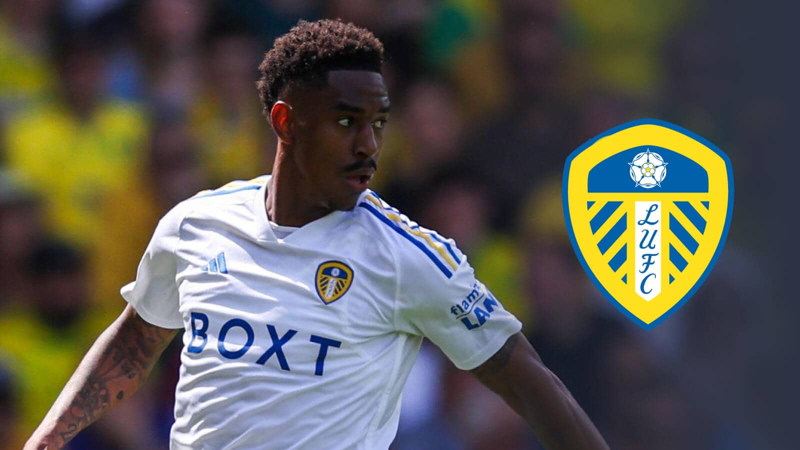 Junior Firpo of Leeds United next to the Leeds United badge