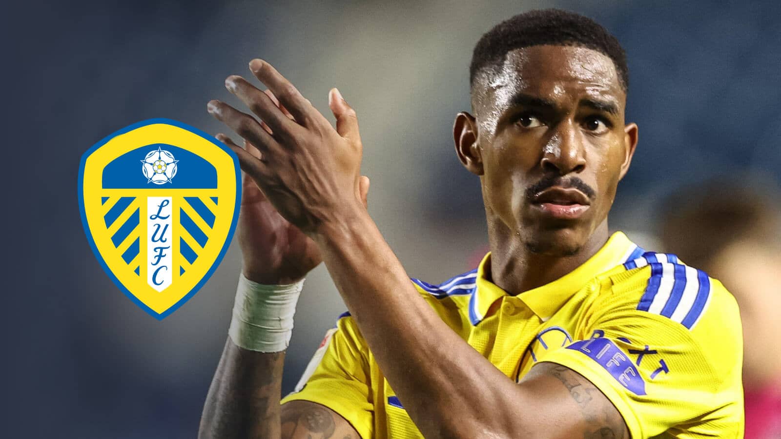 Junior Firpo in Leeds United's away kit for the 2024, 25 season next to the Leeds United badge