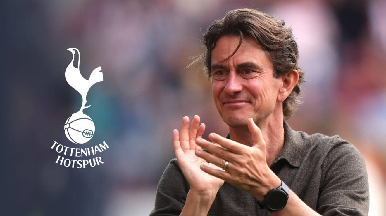 Tottenham Hotspur manager Thomas Frank next to the club crest
