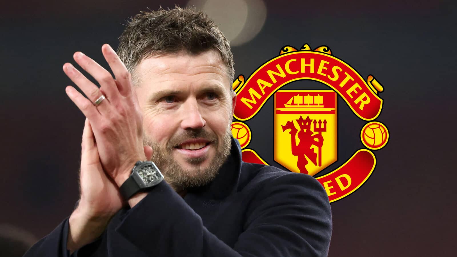 Manchester United manager Michael Carrick next to the Manchester United badge - copyright TEAMtalk