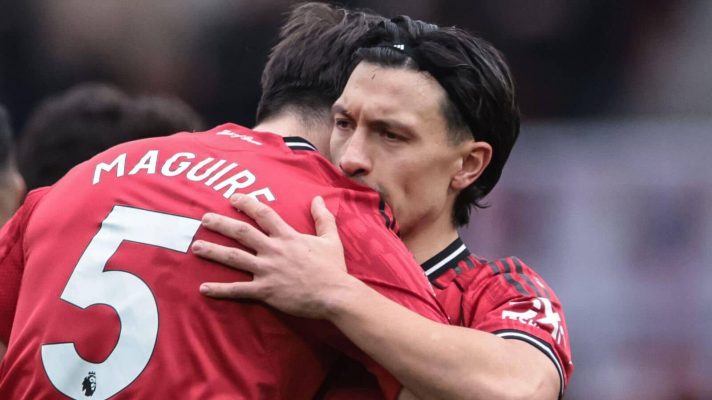 Harry Maguire and Lisandro Martinez hugging during a Man Utd game