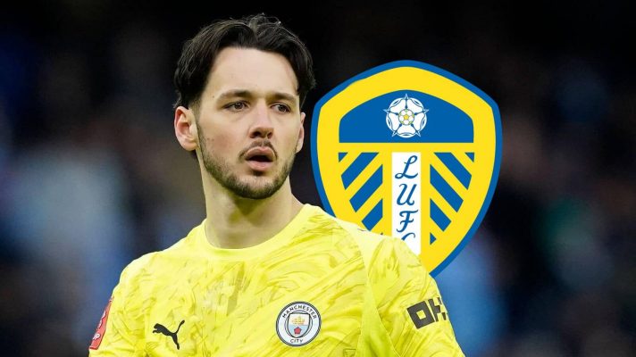 Manchester City star James Trafford with a Leeds United badge