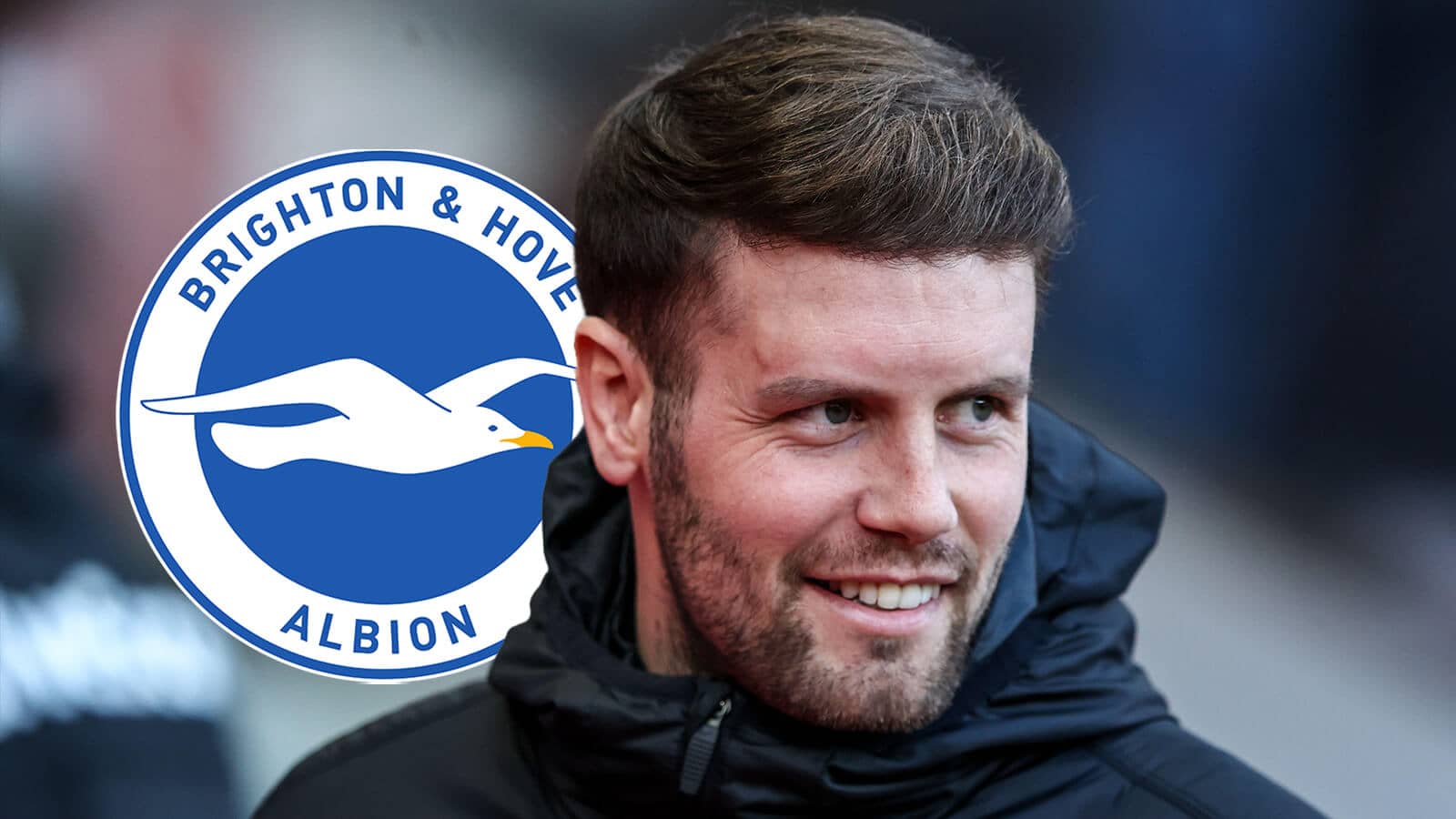 A smiling Brighton manager Fabian Hurzeler next to the club badge