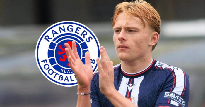 Dundee star Luke Graham with a Rangers badge