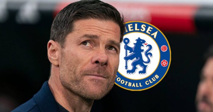 Chelsea manager Xabi Alonso next to the club badge