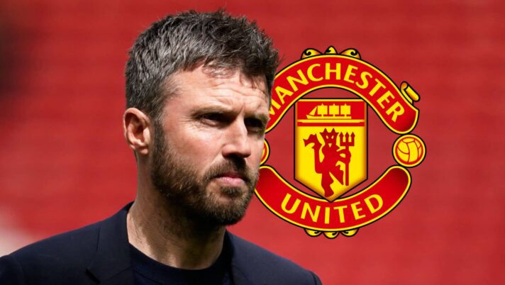 Manchester United boss Michael Carrick next to the club badge