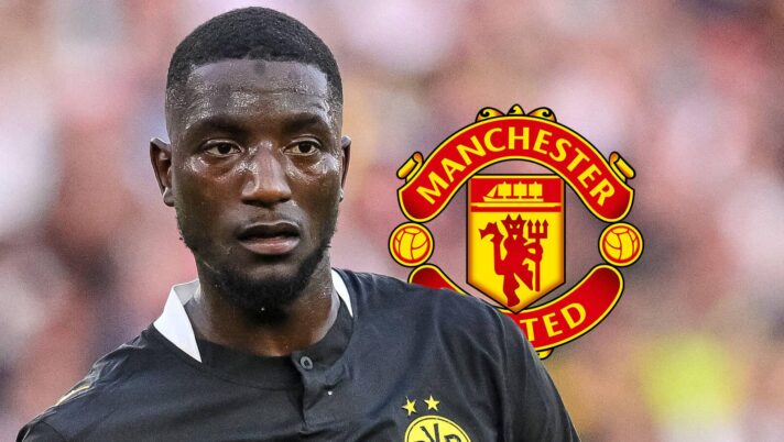 Borussia Dortmund forward Serhou Guirassy with a Man Utd badge