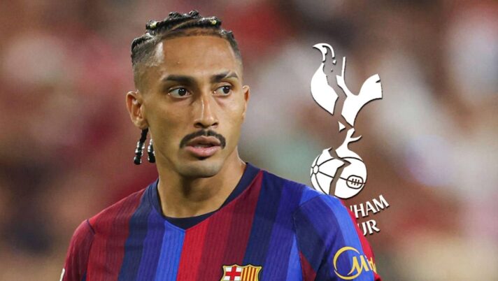 Barcelona star Raphinha with a cracked Tottenham badge